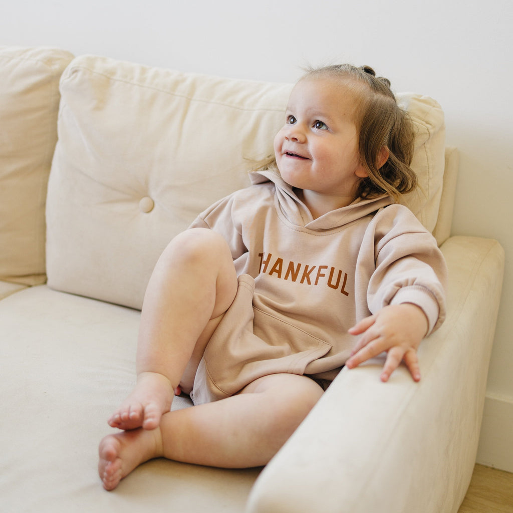 Children's hooded romper with 'THANKFUL' text and long sleeves, worn by toddler