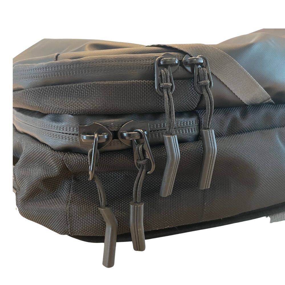 Black travel backpack with green lining, front zippers and top carry handle