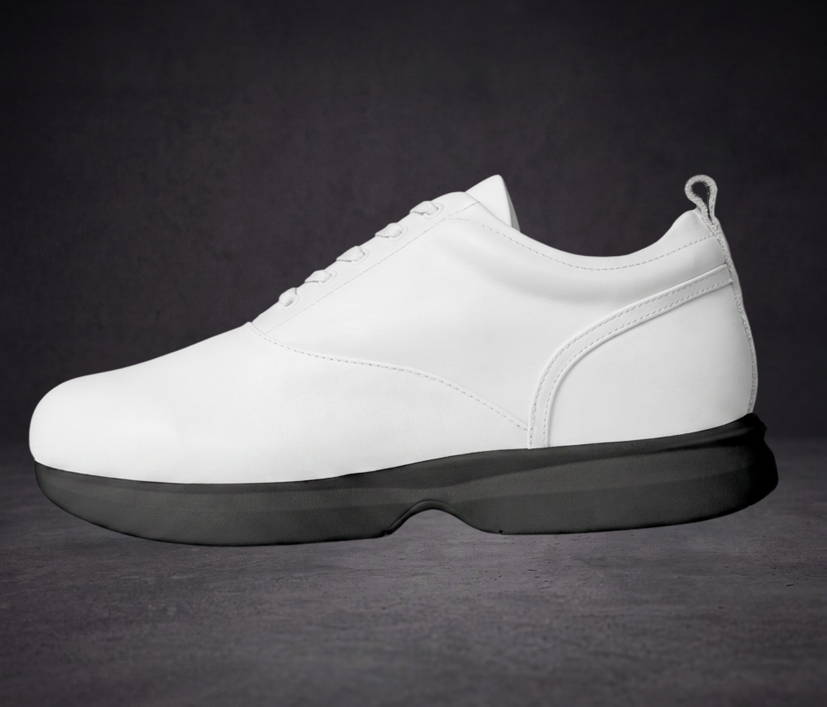 White low-top lace-up sneaker with side panel seams and black platform sole