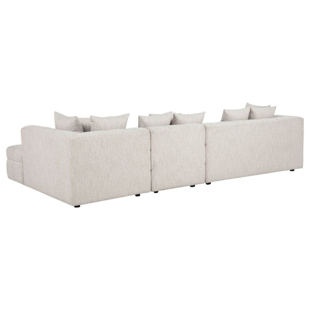Light beige sectional sofa with chaise and multiple back cushions, boxy armrests