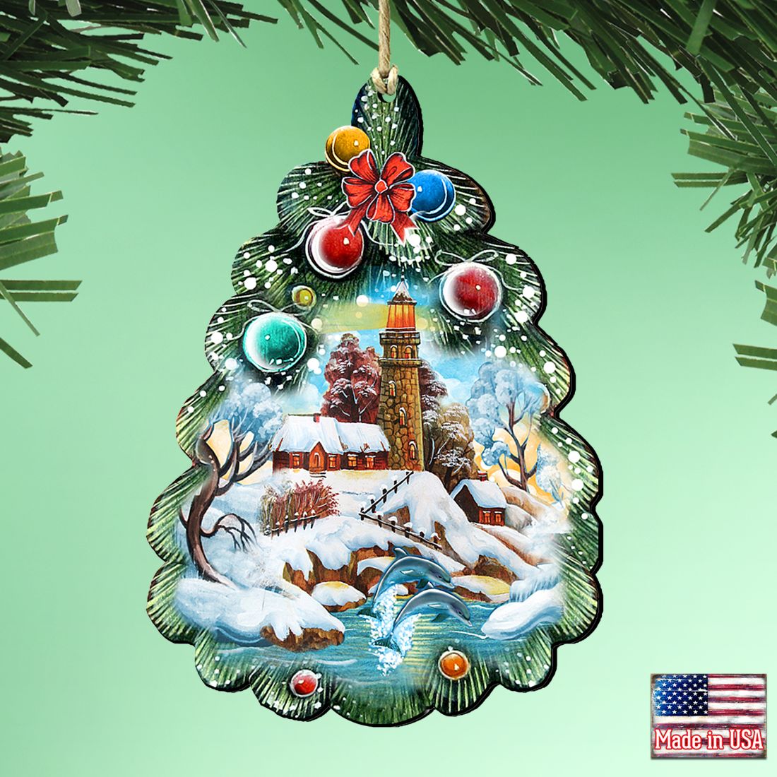 Wooden tree-shaped Christmas ornament with lighthouse artwork, hanging loop, and red flower topper
