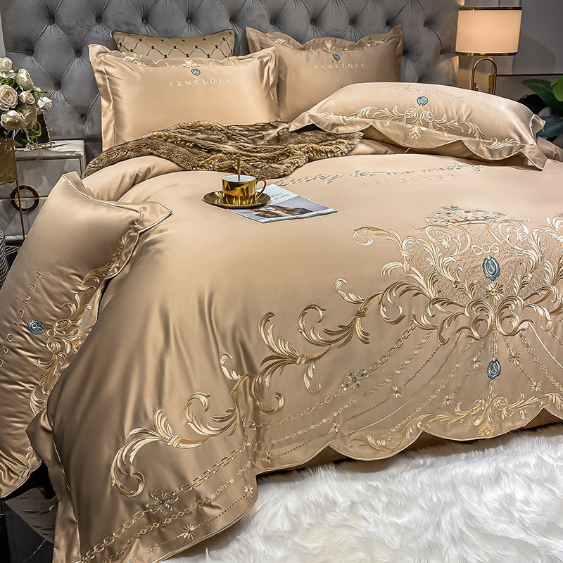 Champagne beige quilted bed sheet set with gold and blue ornate embroidery and pillowcases