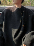 Men's dark knitted sweater with ribbed crew neck and gold-tone button placket