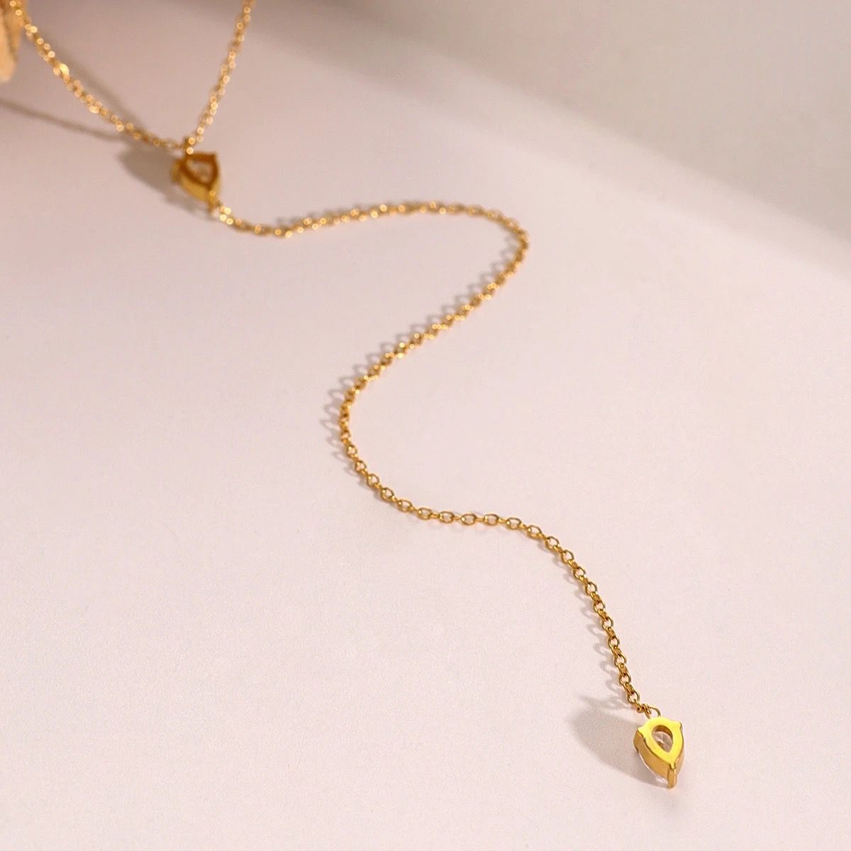 Gold-tone necklace with teardrop crystal drop and smooth link chain