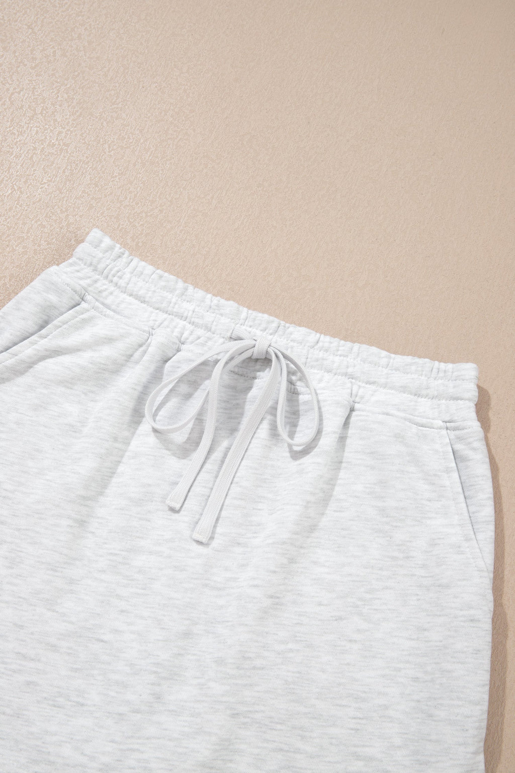 Light grey skort shorts with elastic waist and front drawstring ties