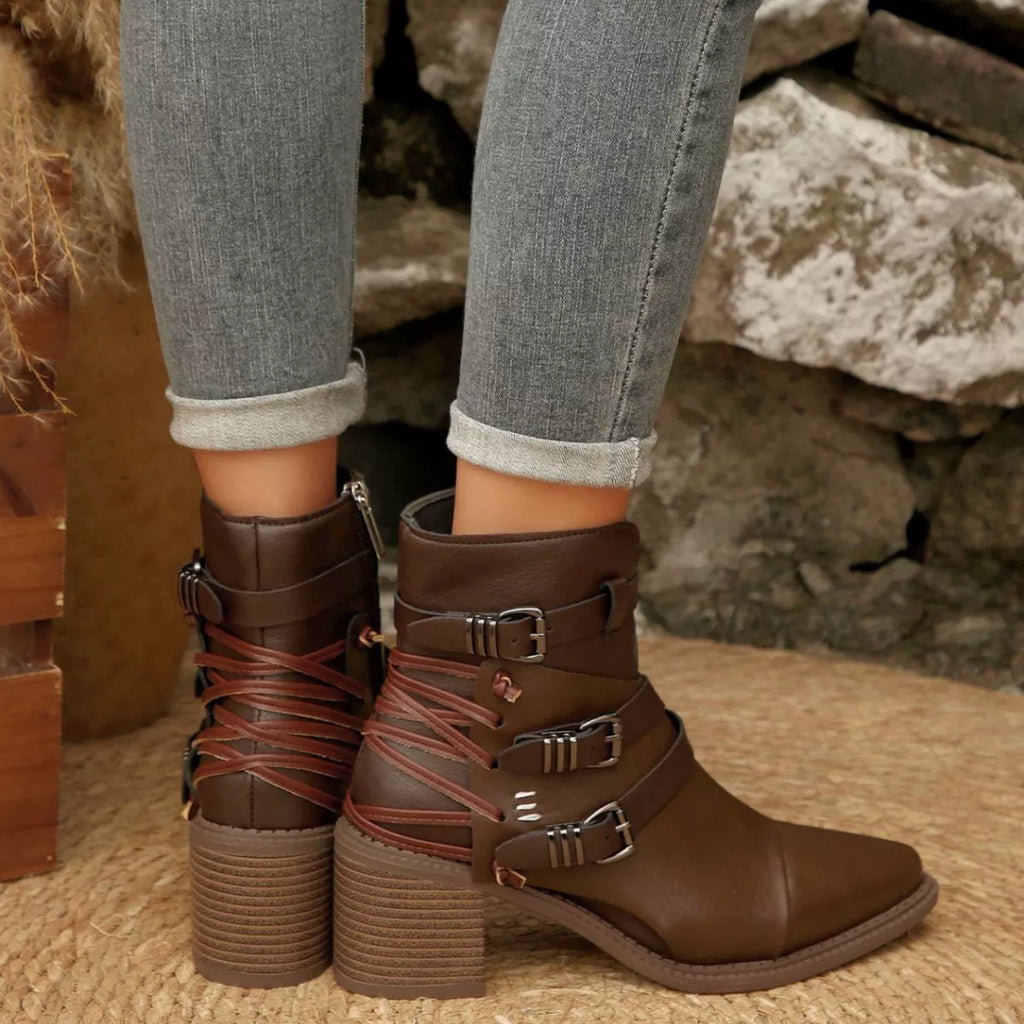 Dark brown ankle boots with point toe, buckle straps, and block heels