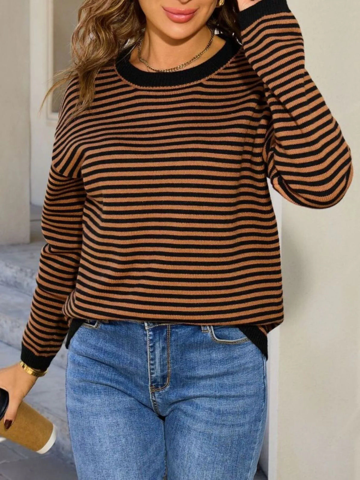 Black-and-tan striped round-neck sweater with long sleeves and ribbed cuffs