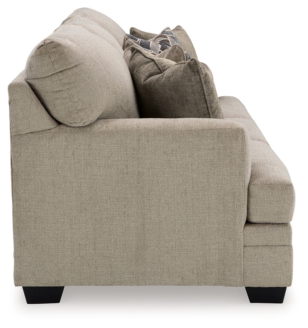 Upholstered armchair with deep seat, rounded back and dark feet, light beige fabric