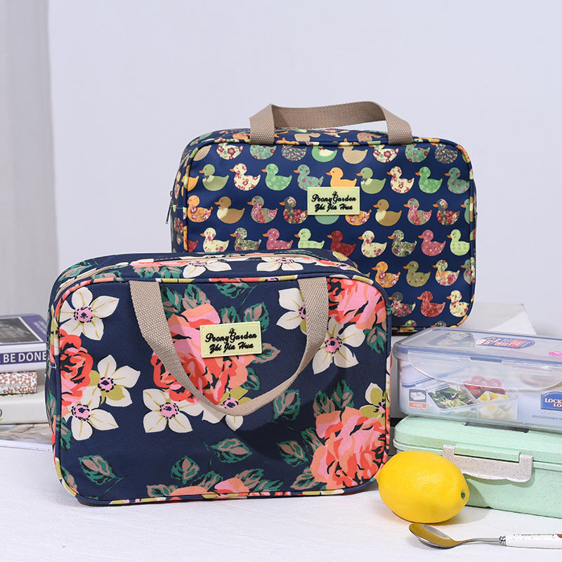 Navy travel toiletry bag with colorful animal print, top handle and zip closure