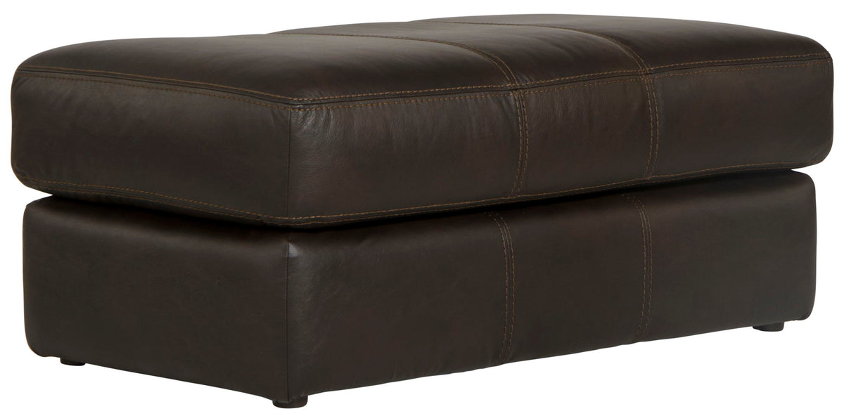 Chocolate leather ottoman with thick padded top and square base, visible corner stitching.