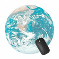 Round Earth-style map mouse pad in blue and green with black mouse on top