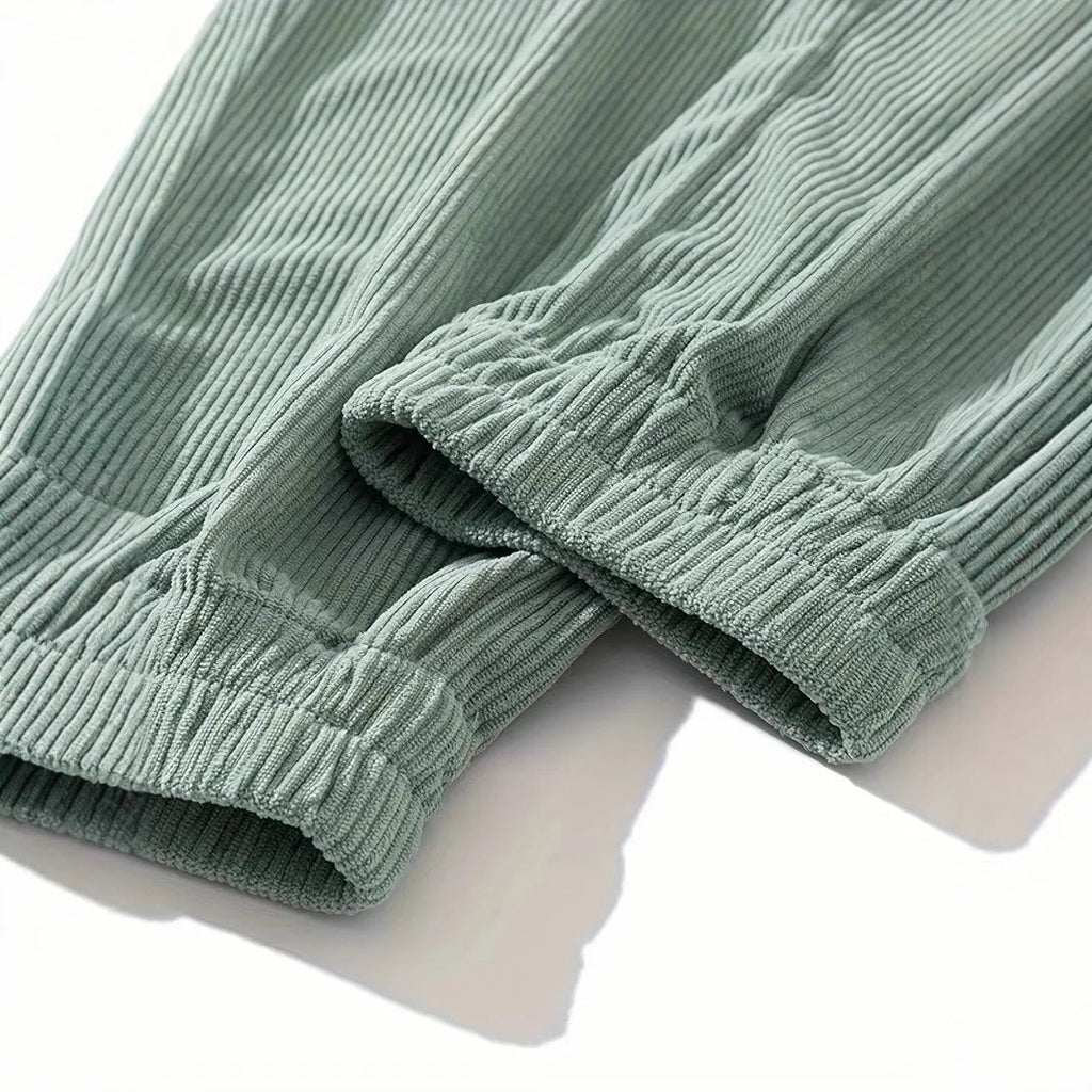 Light green corduroy fabric close-up with elastic cuff detailing
