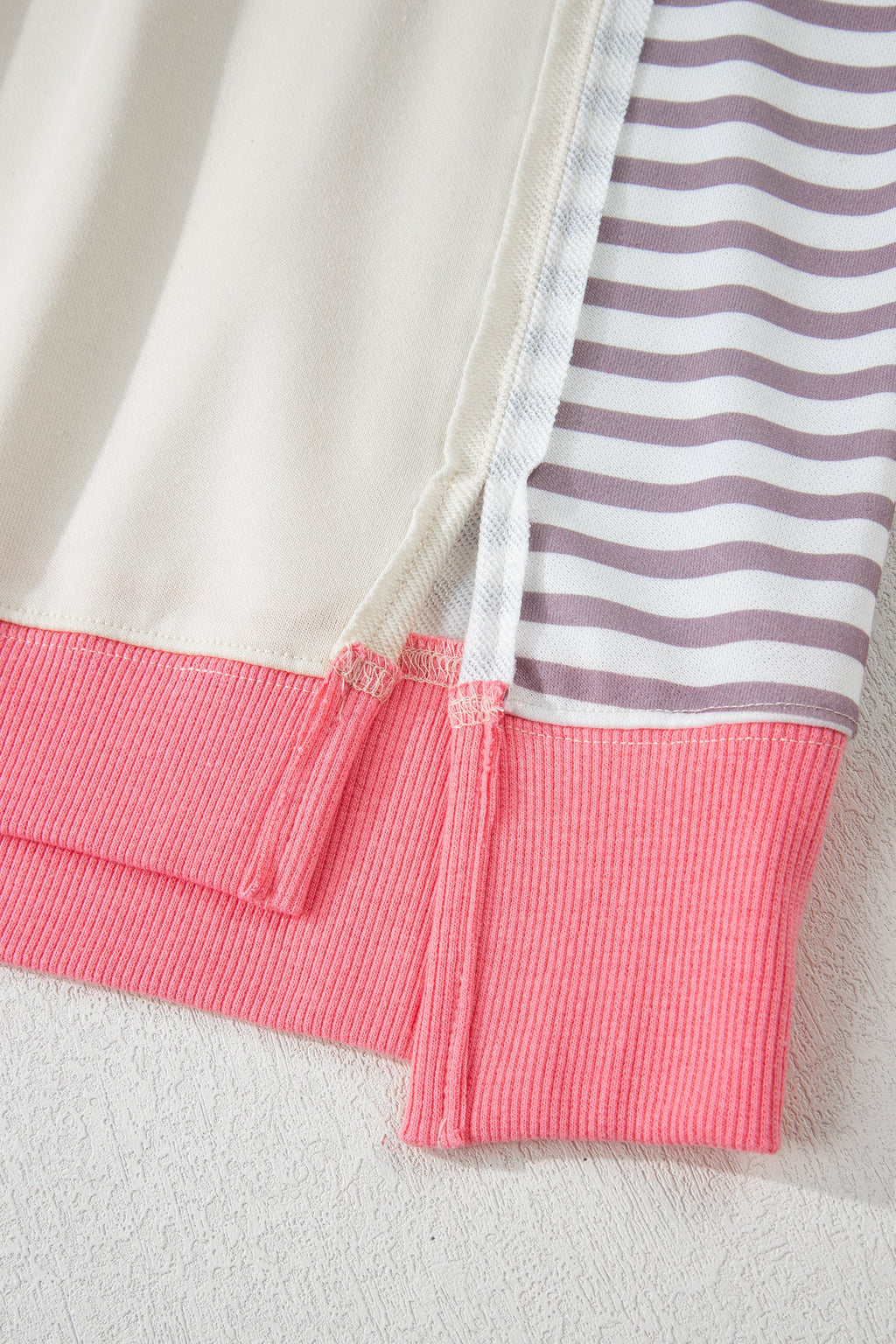 Cream sweatshirt with pink hem band and striped sleeve patchwork detail