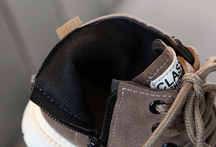 Brown ankle boot close-up with black lining and lace eyelets