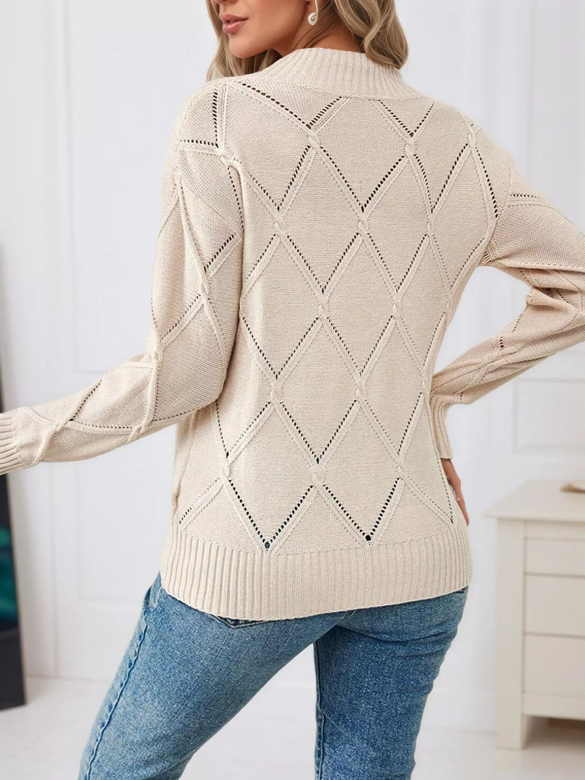 Beige diamond eyelet knit top, back view with diamond pattern and ribbed hem