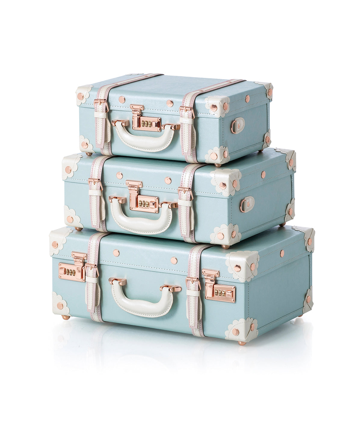 Stack of three sky-blue briefcases with floral trim and rose-gold handles.