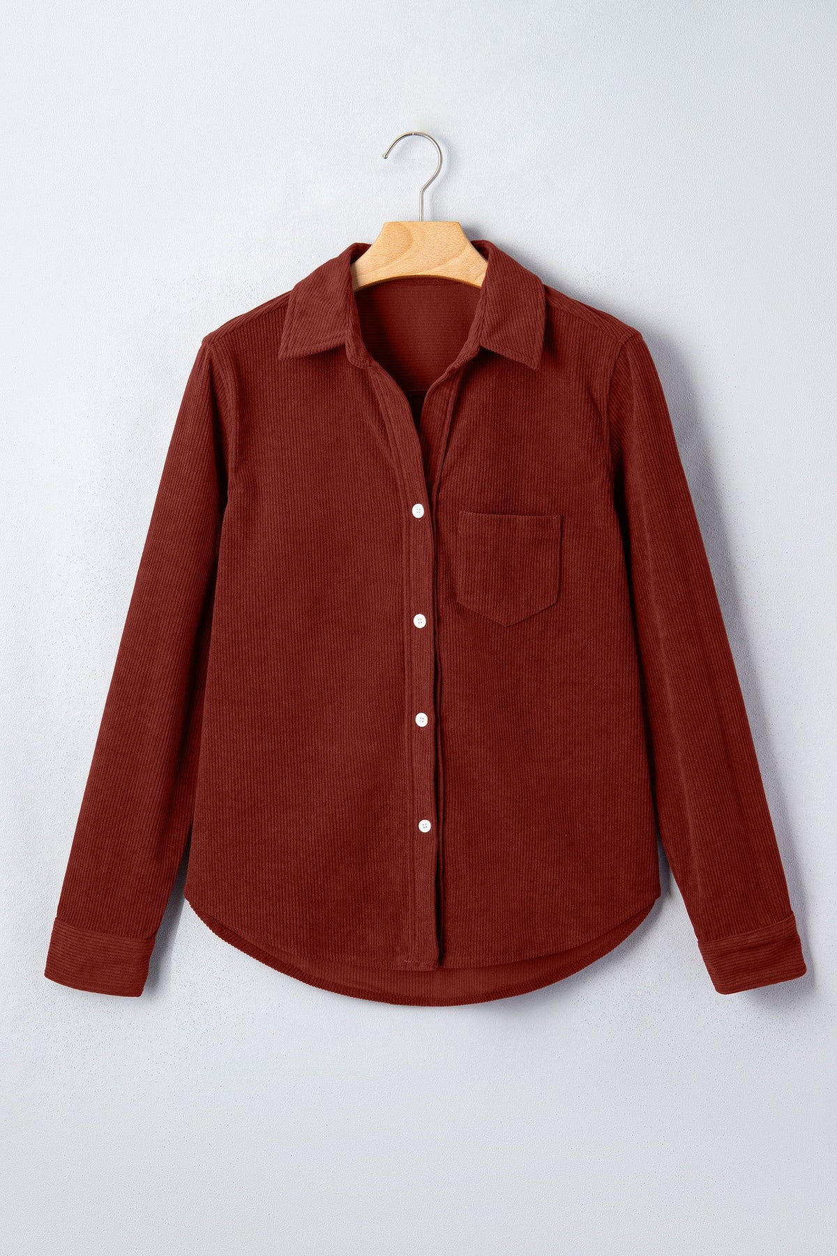 Clay corduroy long-sleeve button-up shirt on hanger, chest pocket and white buttons.
