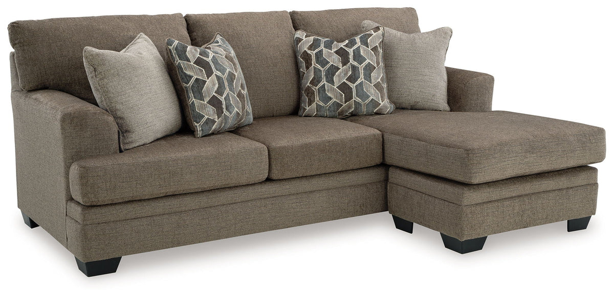 Upholstered sectional sofa with chaise and three throw pillows, gray-brown fabric
