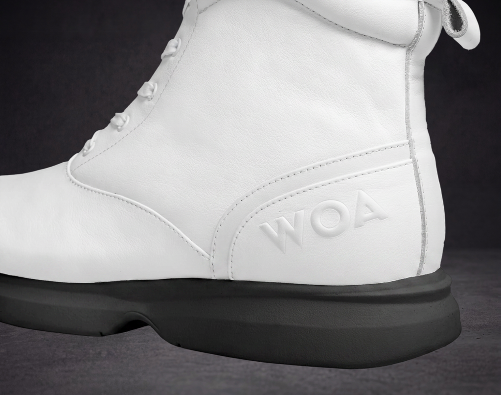 White WOA boot quarter close-up with embossed WOA logo and black sole