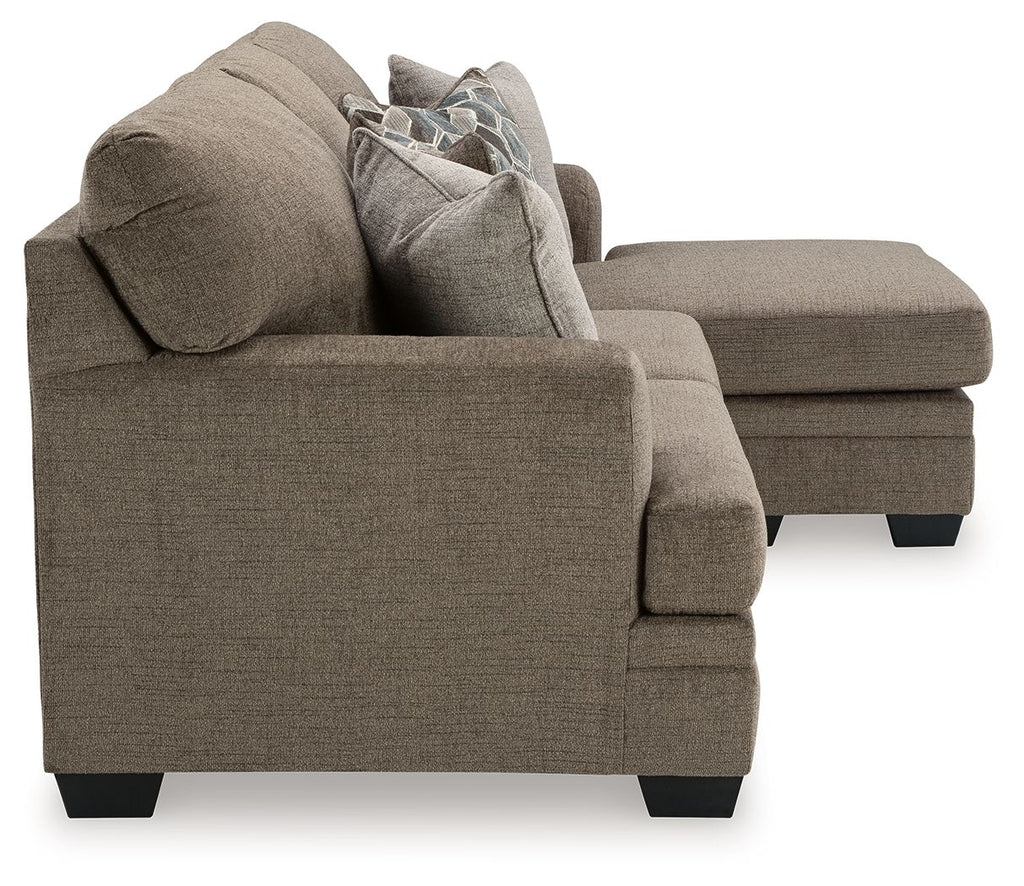 Upholstered sectional sofa with chaise, plush back pillows and gray-brown fabric