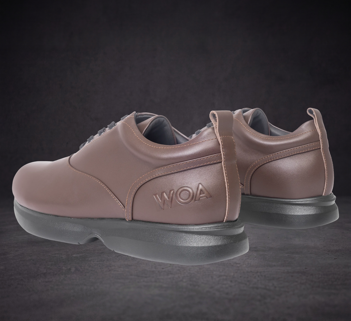 Taupe WOA low-top sneaker back view with heel pull tab and cushioned sole