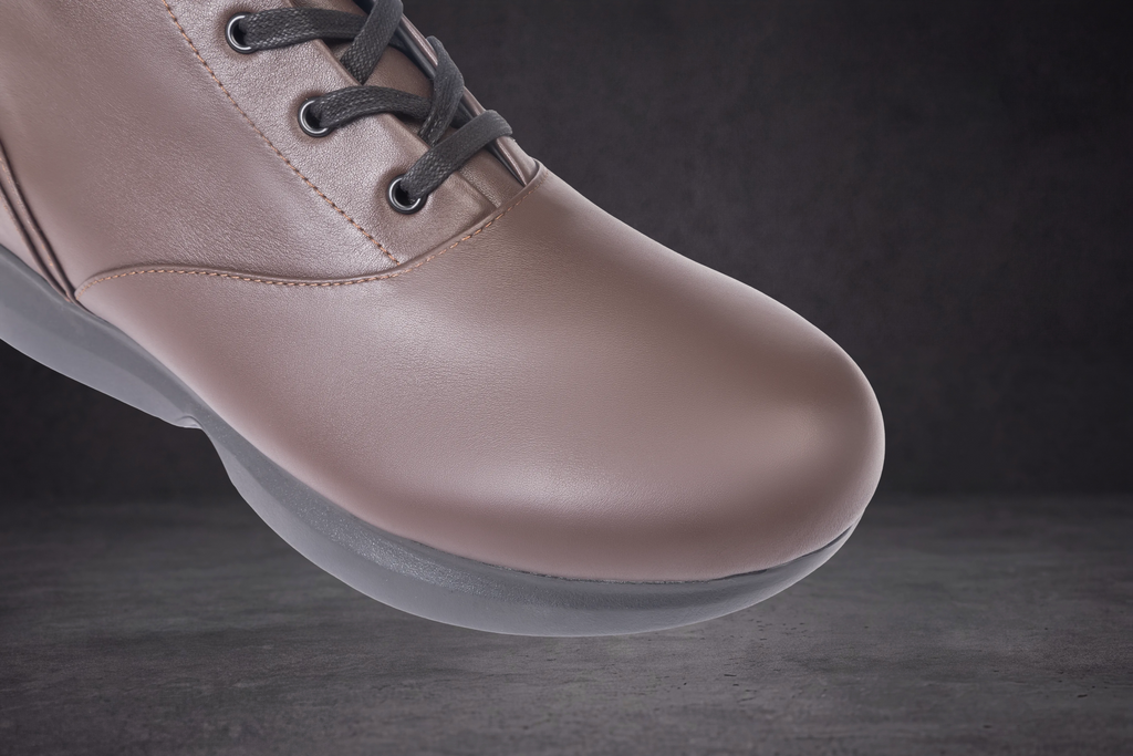 WOA taupe lace-up boot showing smooth toe and gray rubber outsole edge