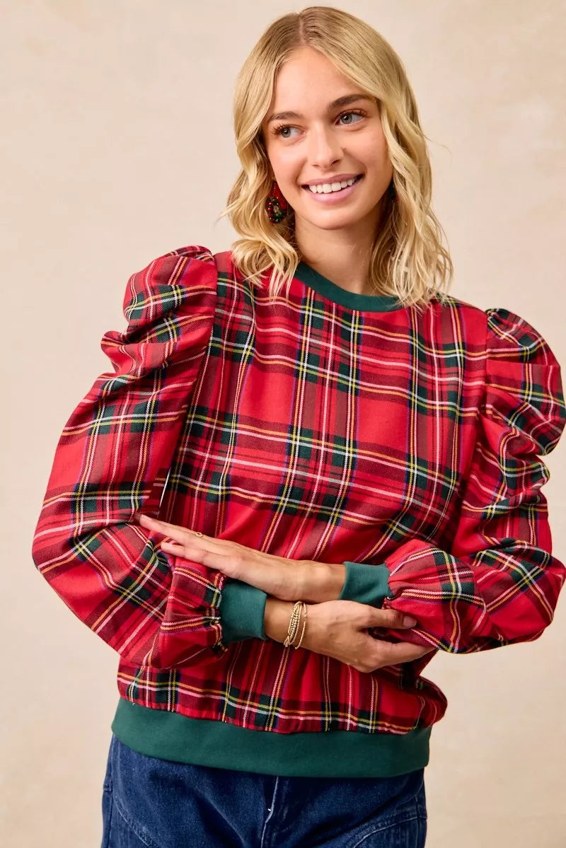 Red plaid long-sleeve top with exaggerated shoulders and green crew neck, front view