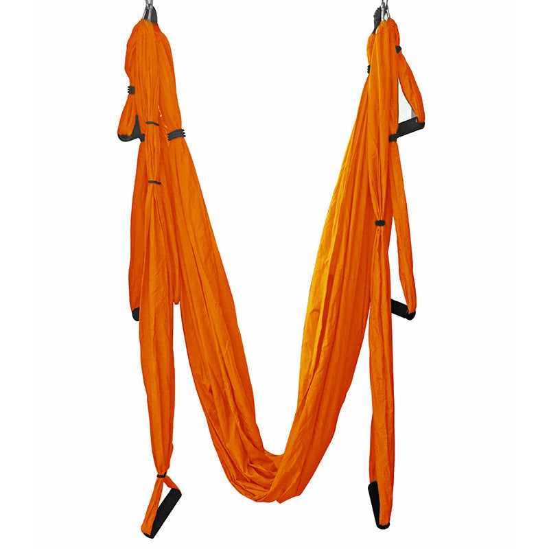Orange aerial yoga hammock swing with hanging loops and end foot straps