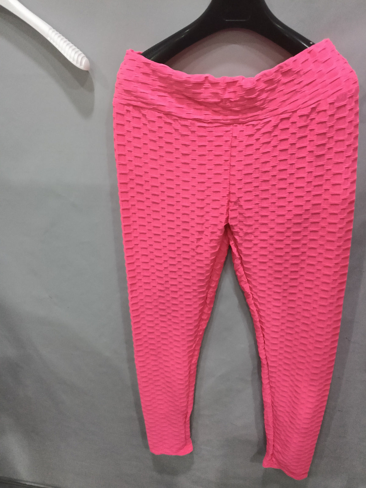 Bright pink scrunch leggings with textured pattern and booty-lifting seam, no pocket.