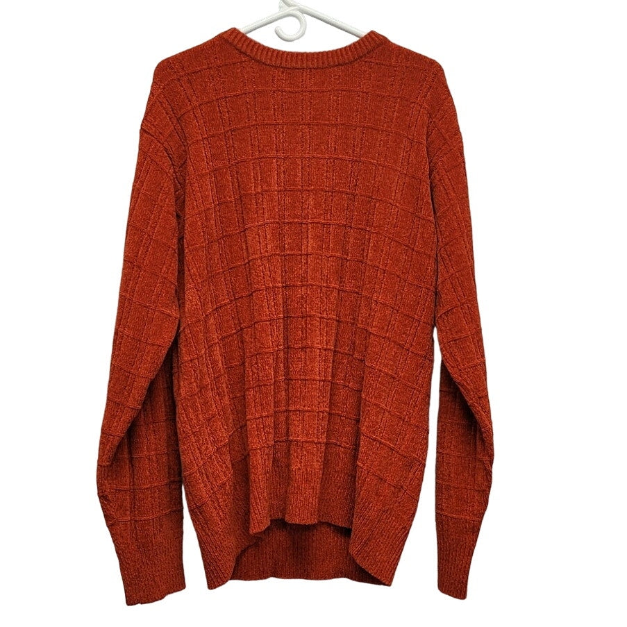 Orange textured knit crewneck sweater with grid pattern and long sleeves