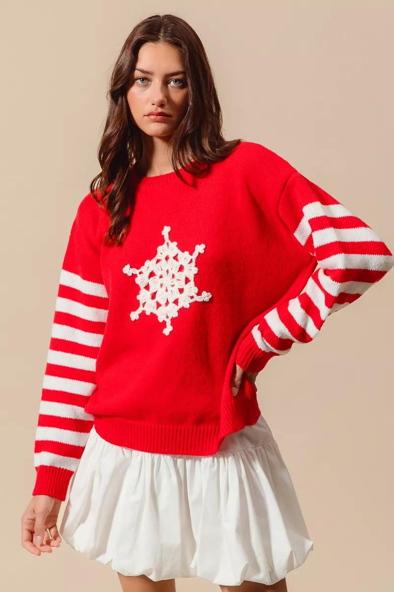 Red Christmas sweater with white crochet snowflake front and striped red-and-ivory sleeves