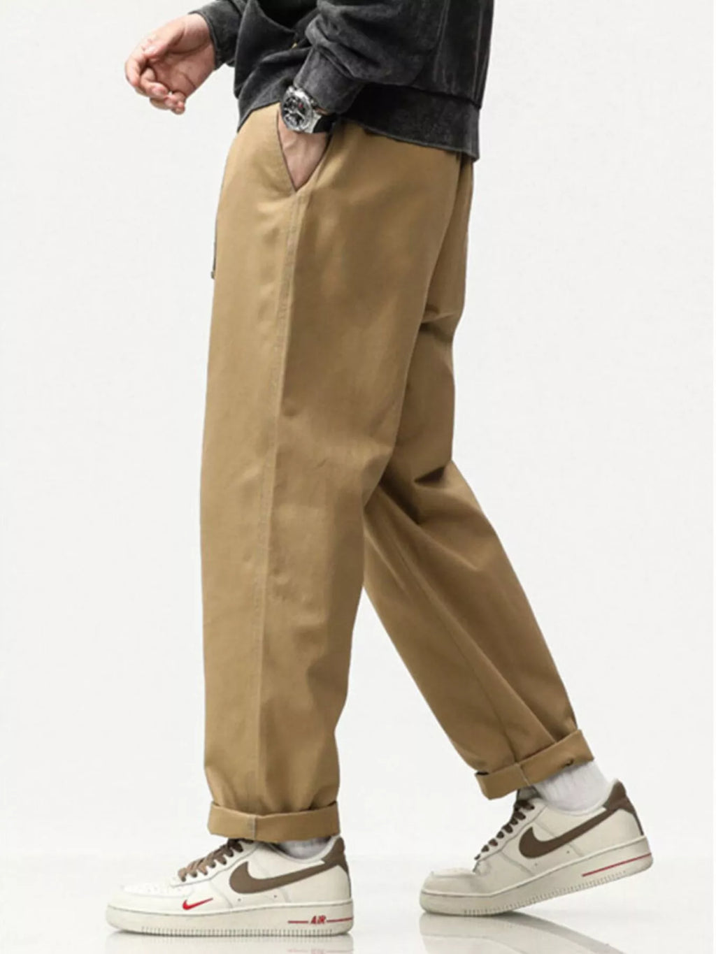 Khaki loose pants, angled side view, cuffed hem and slanted side pockets