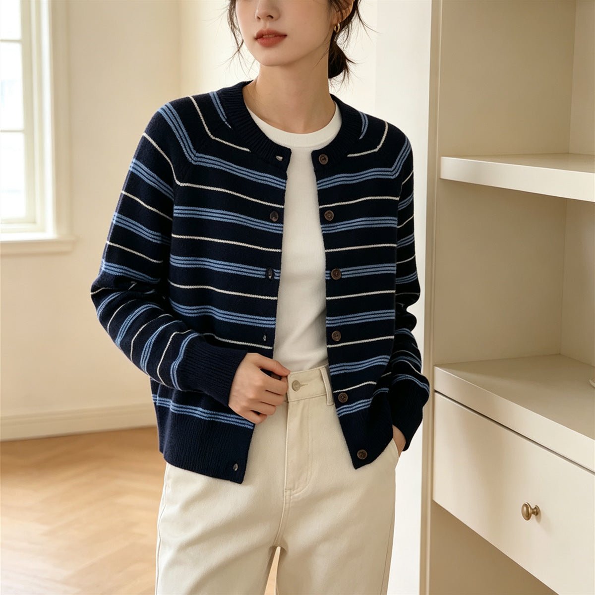 Navy striped cardigan with button front, long sleeves, contrasting light horizontal stripes