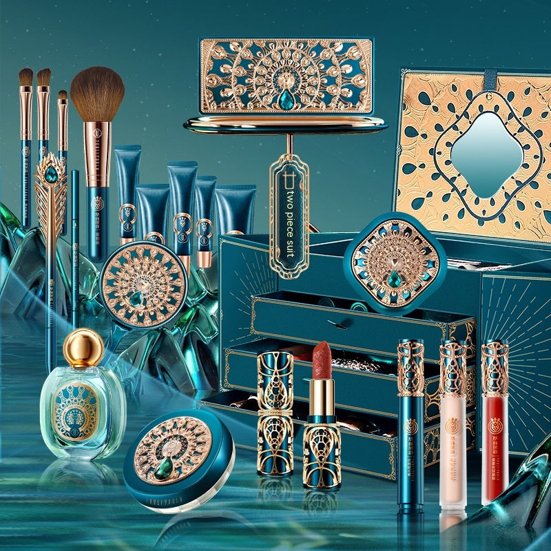Blue and gold makeup set with palette, brushes, lip colors, compact, and bottles