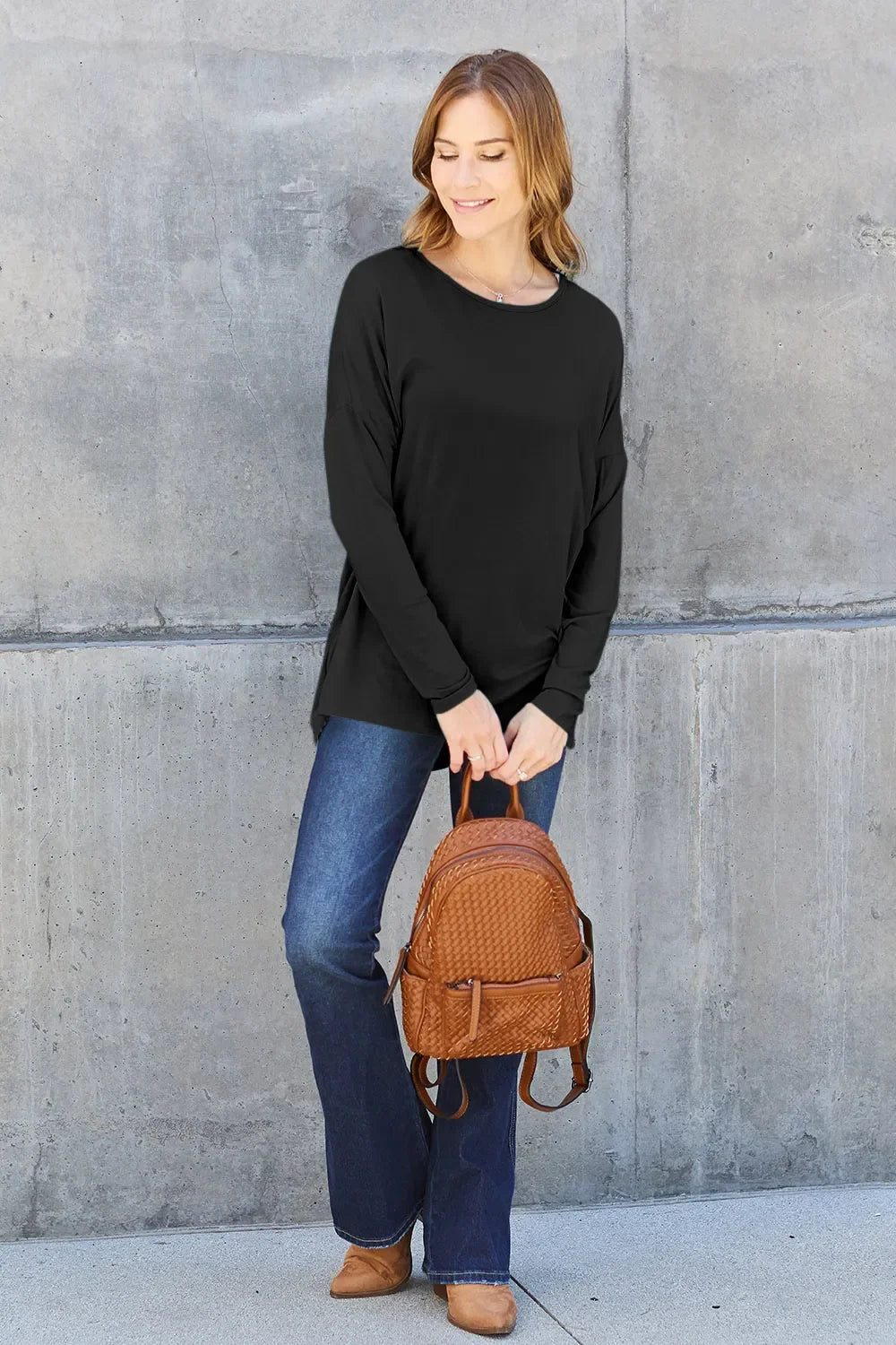 Black relaxed long sleeve crewneck tee with curved hem