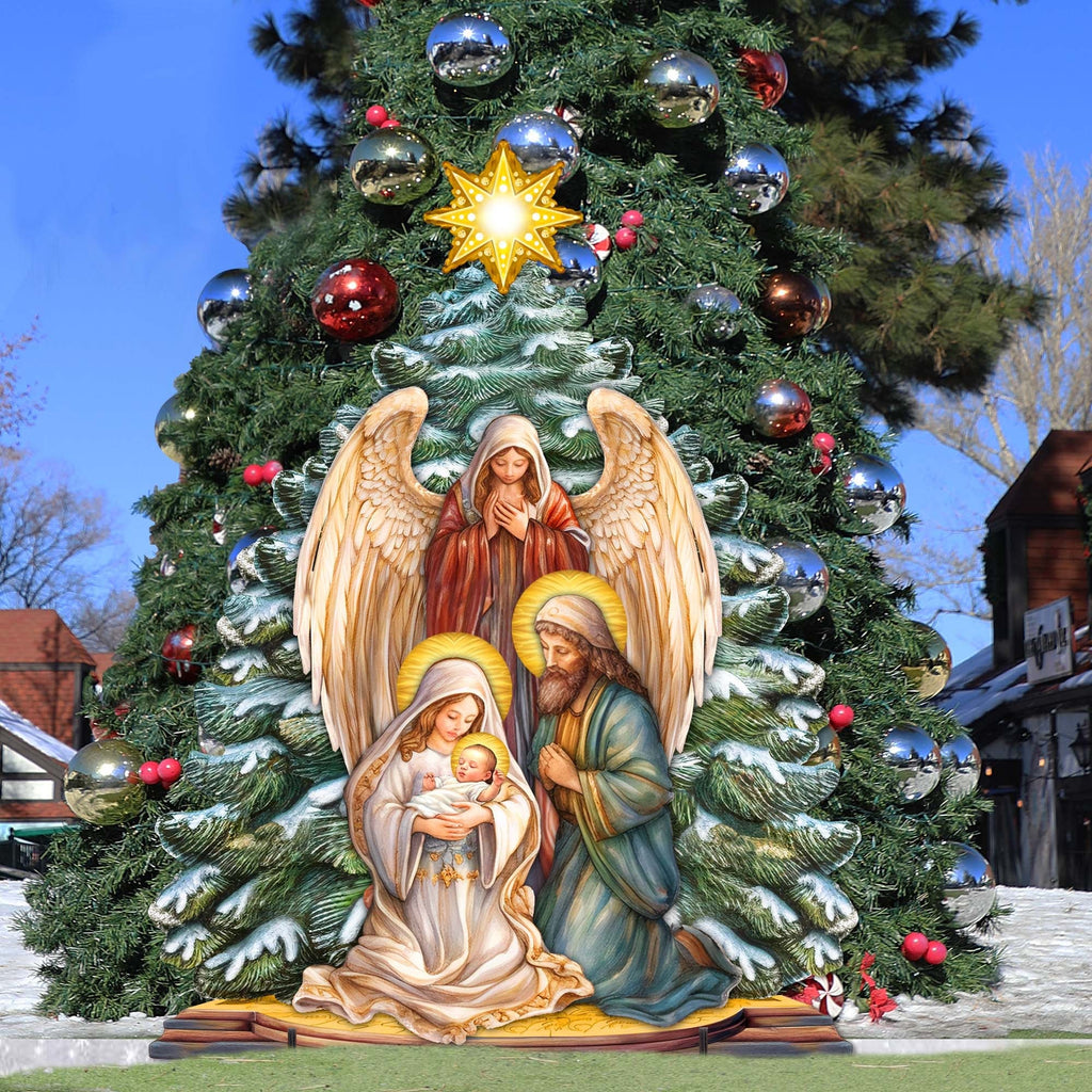Outdoor nativity outdoor decor on Christmas tree with glowing star topper and angel wings