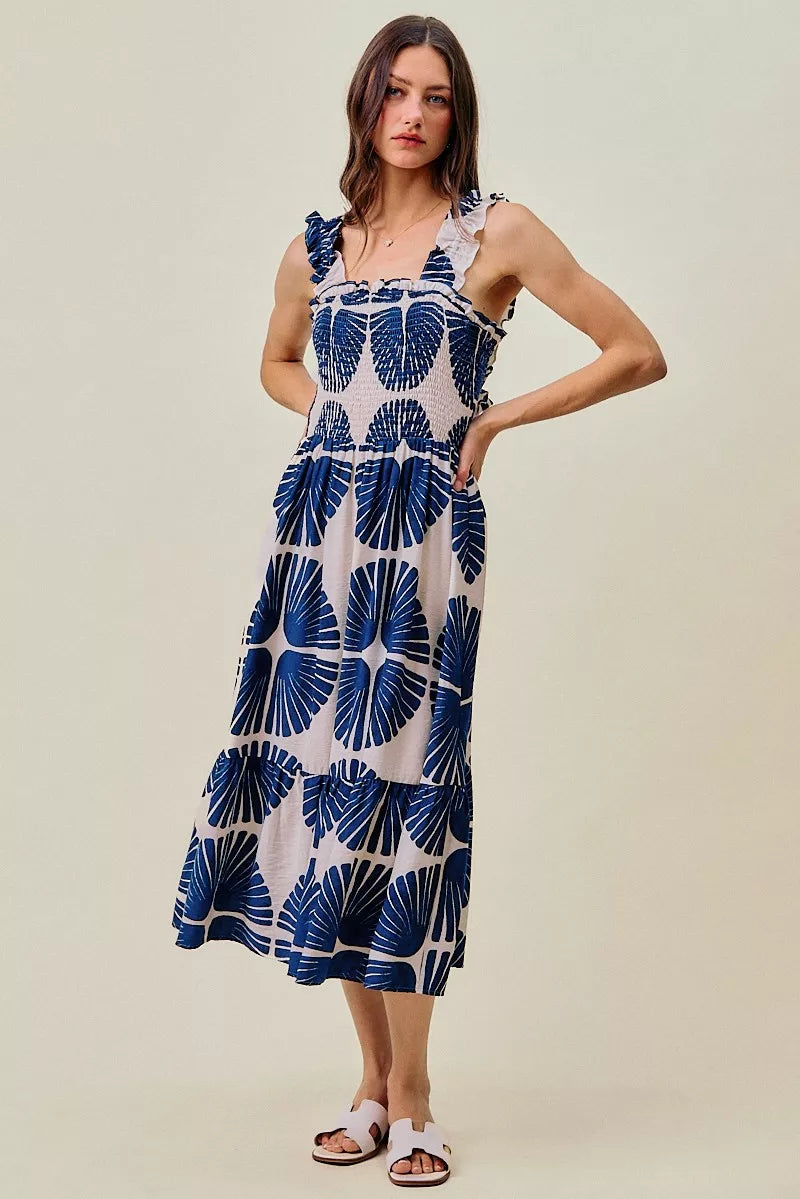 Front view navy and white abstract print smocked bodice tiered midi dress