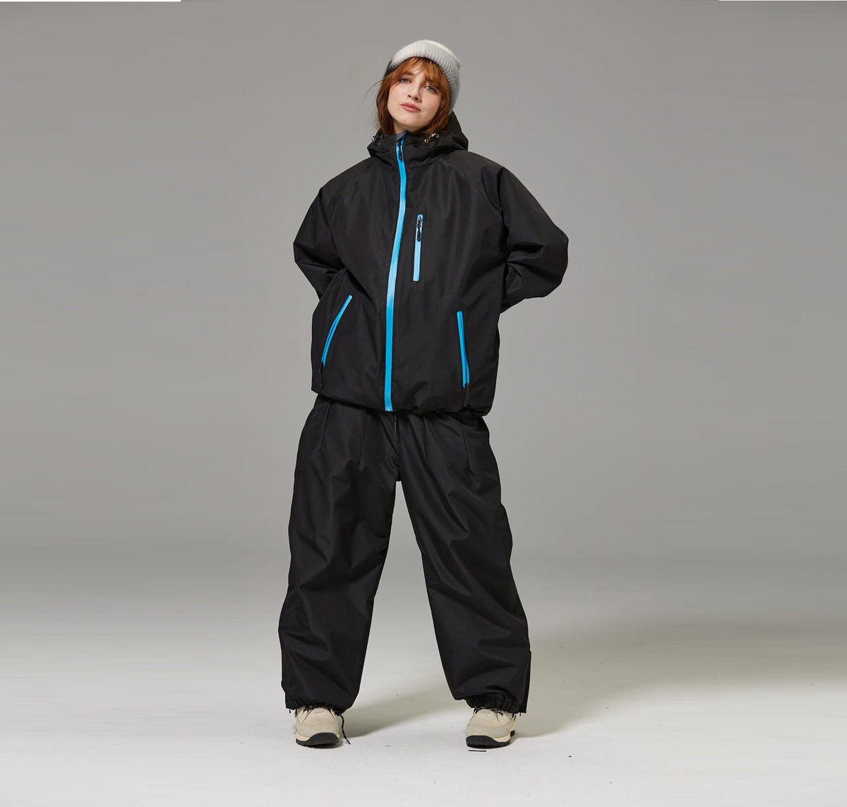 Black unisex ski suit set with blue-trim hooded jacket and loose pants