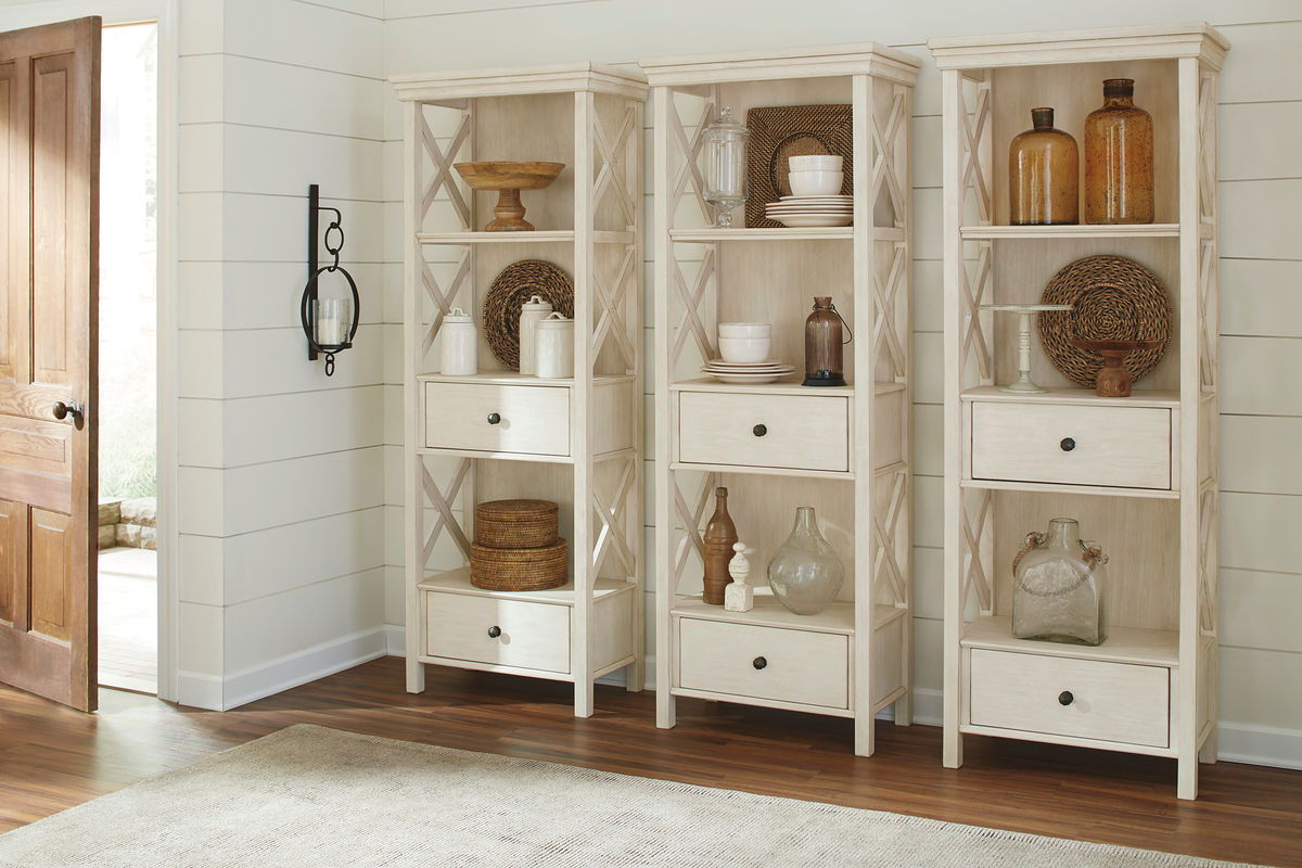 Beige corner display cabinet unit with open shelves and drawers for table set storage.