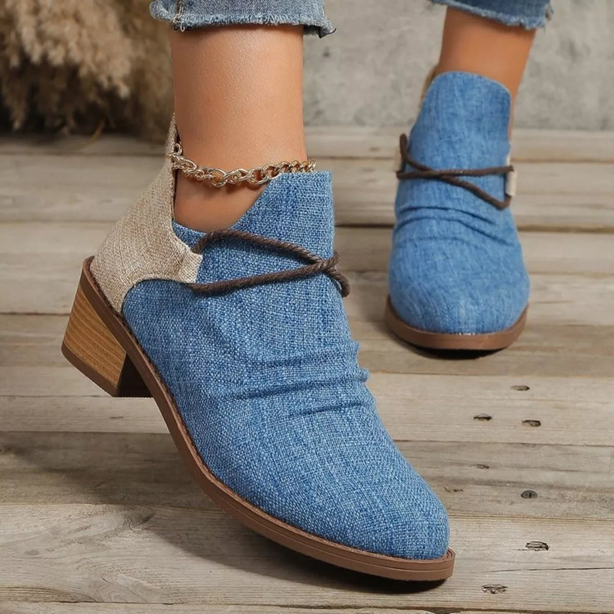 Dusty blue ankle boots showing lace-up side detail and block heel