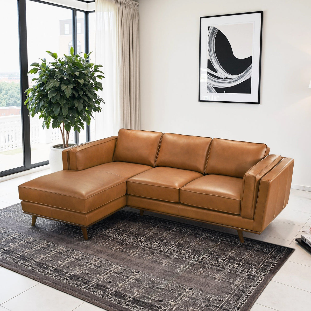Light brown sectional sofa with chaise-style corner, padded armrests and square seat cushions