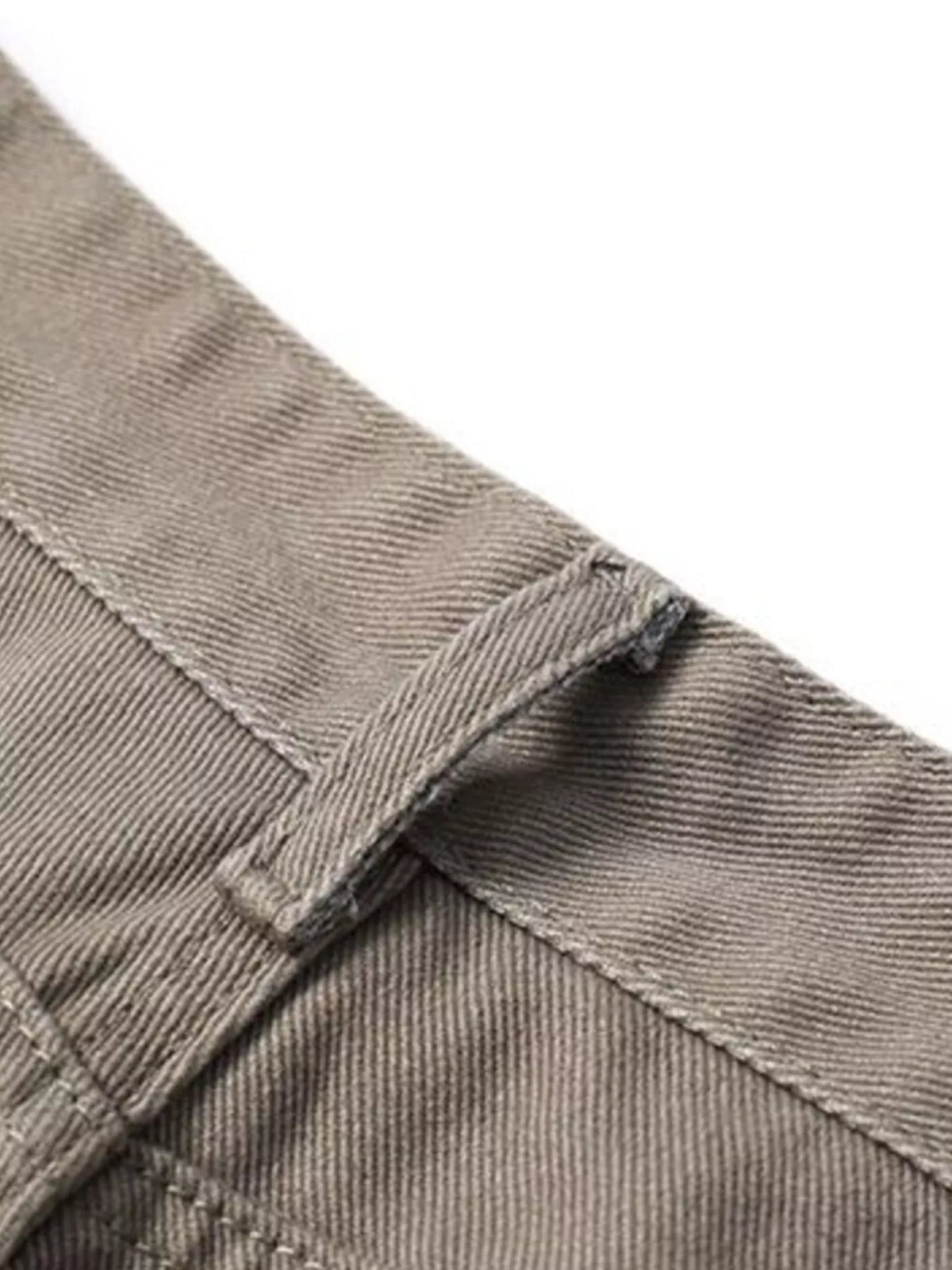 Brown pants waistband with belt loops and stitched crossover seam