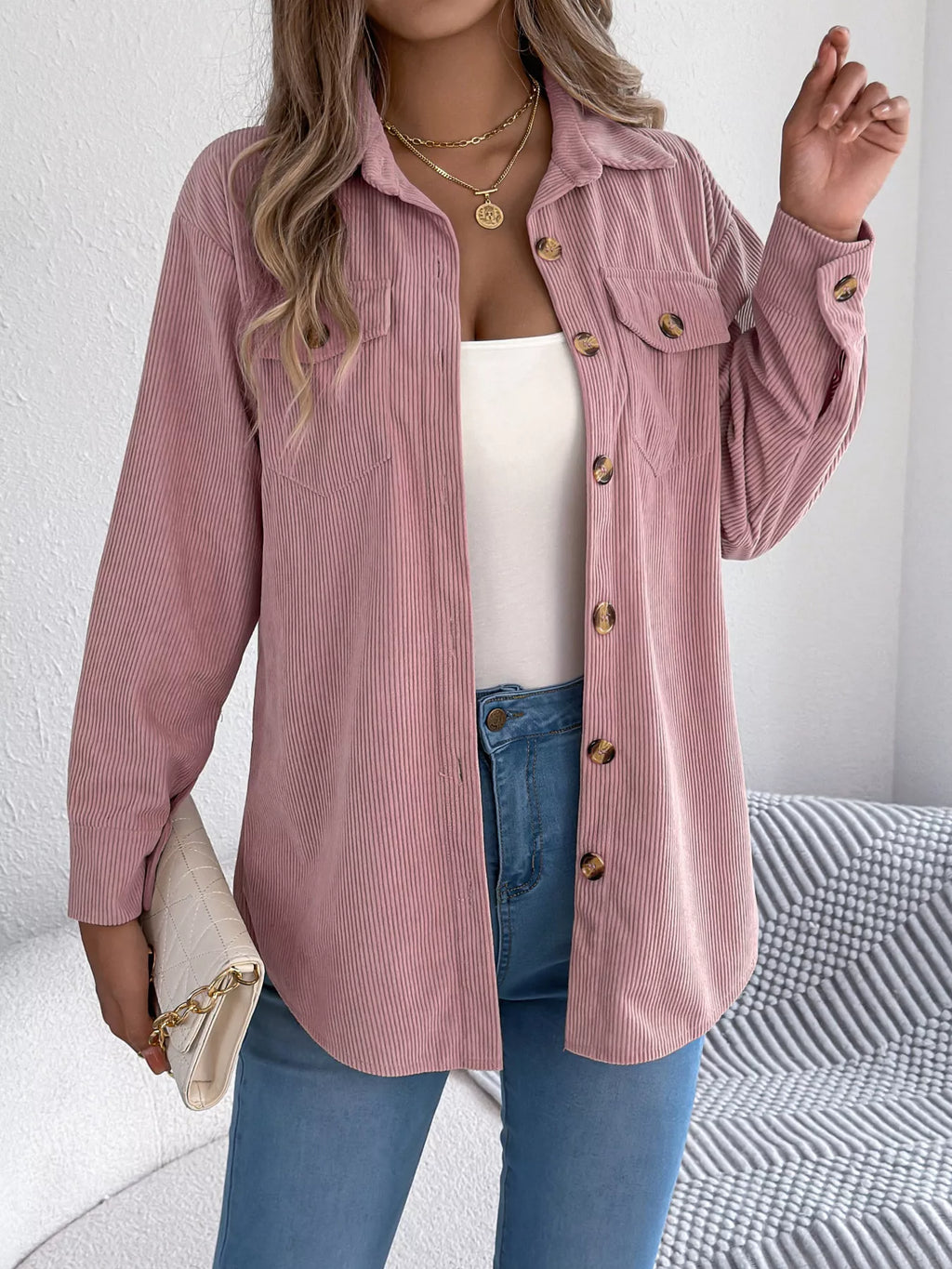 Pink corduroy shacket with spread collar, flap pockets, and gold button detail