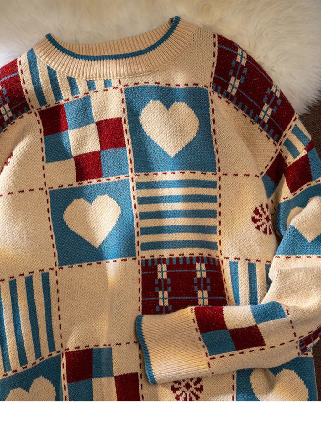 Men's patchwork heart sweater in beige with teal and red plaid blocks, front view
