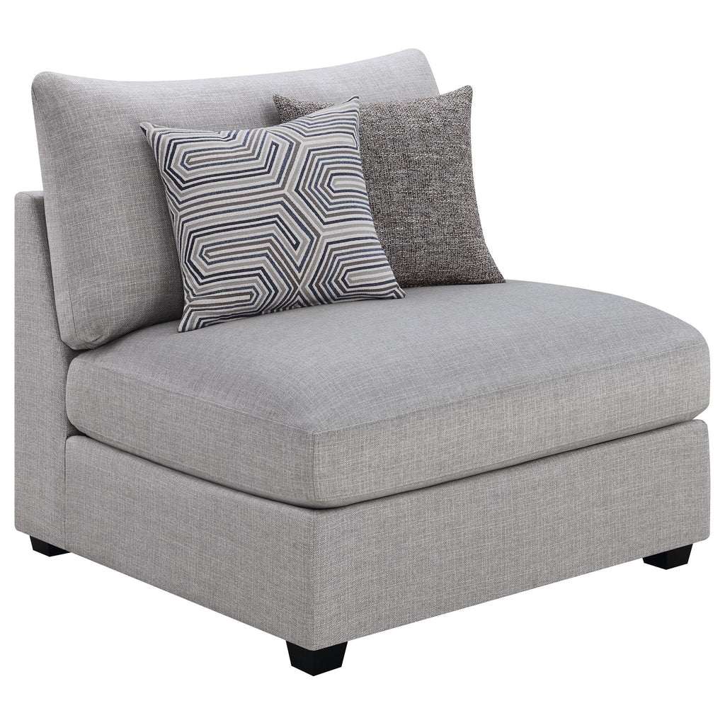 Grey upholstered chaise sectional with geometric patterned and solid pillows