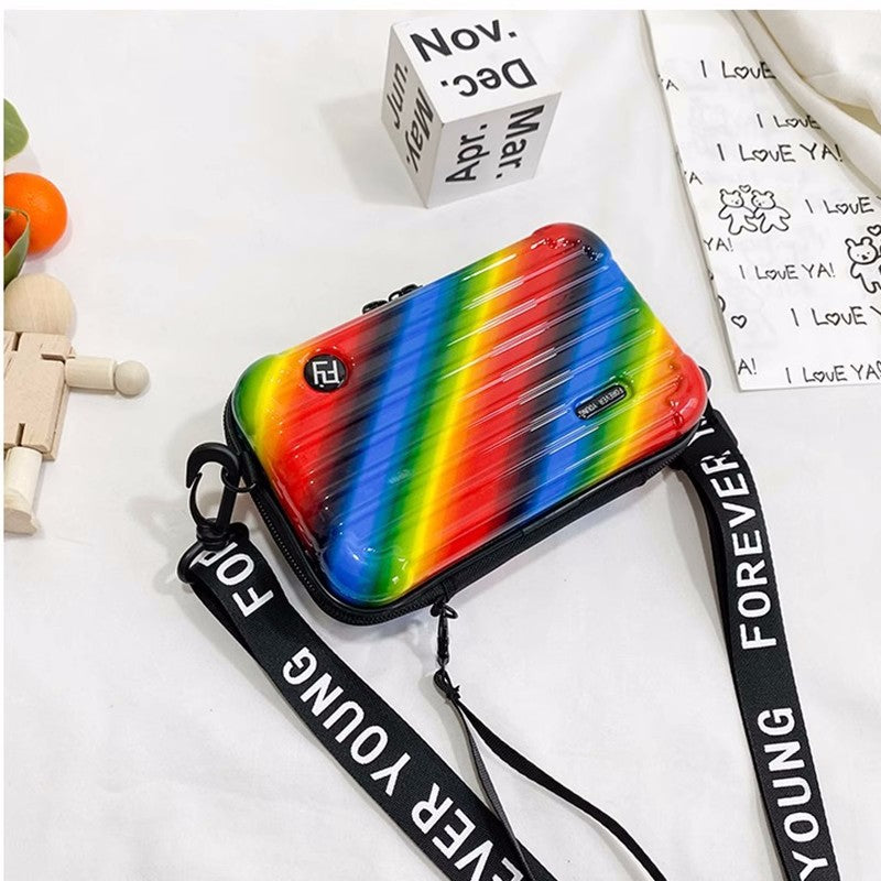 Cosmetic bag with rainbow gradient stripe print, black trim, zip top, strap