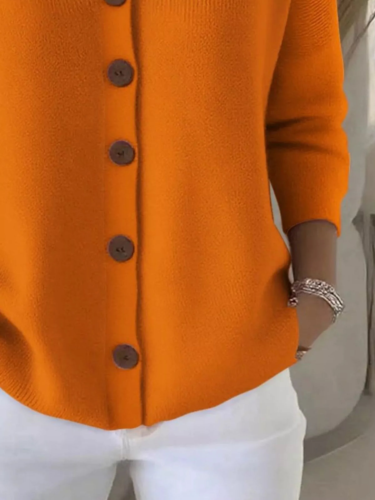 Orange button-front hooded soft knit cardigan hem and cuff with round dark buttons
