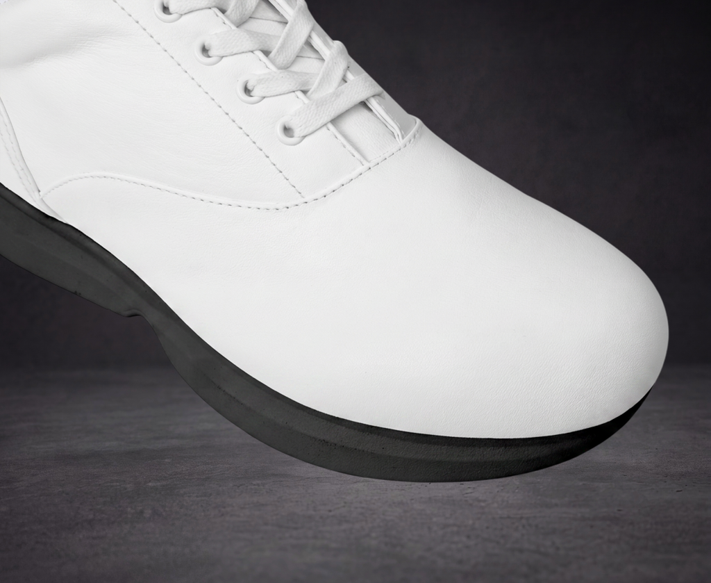 Close-up of white sneaker toe and lace area with black platform sole