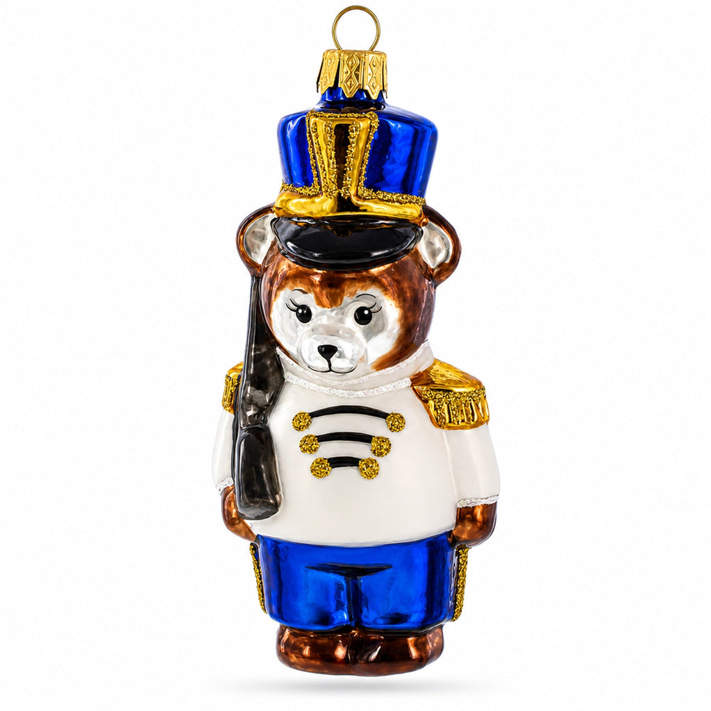 Glass nutcracker bear ornament, blue hat with gold trim, brown suit, white shirt front