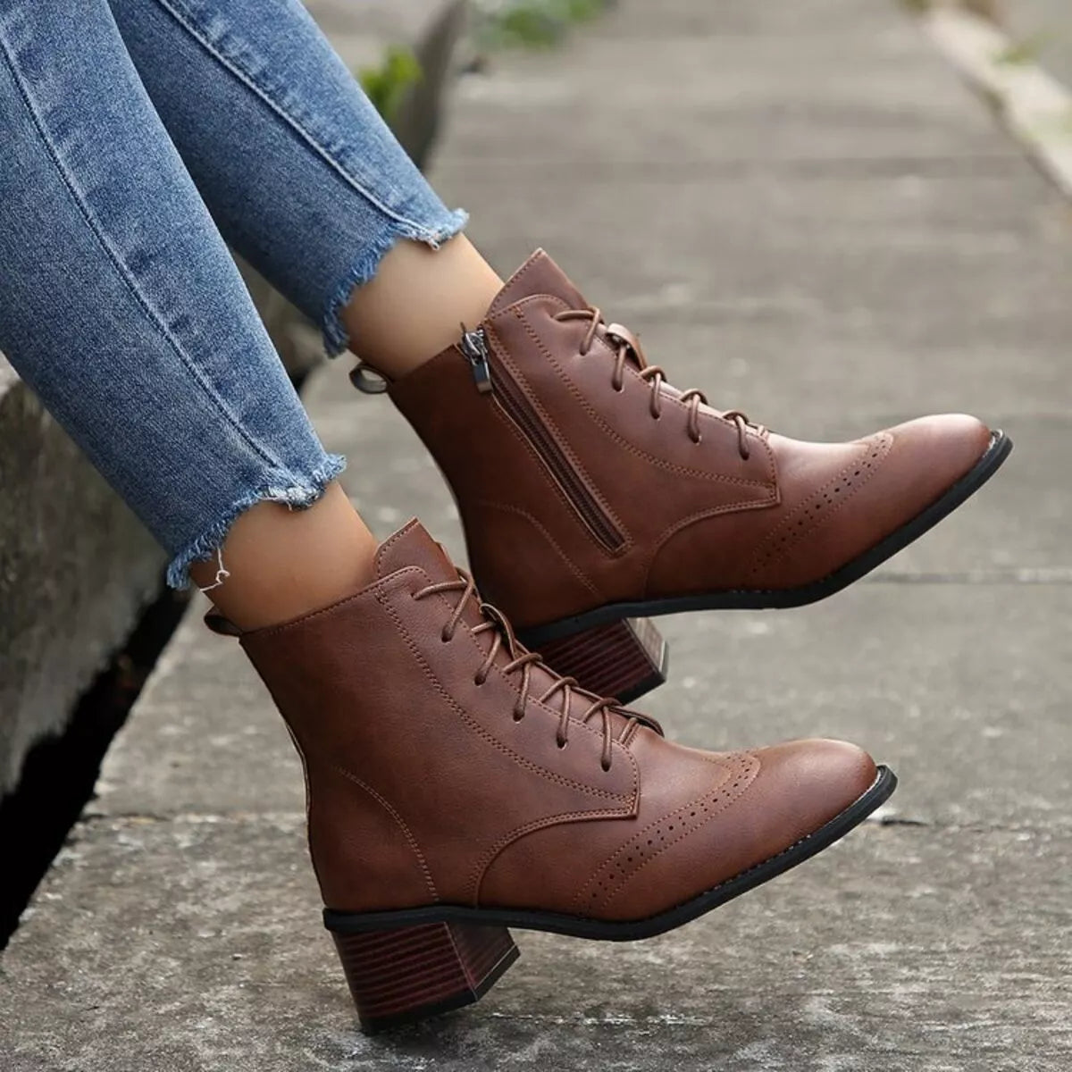Brown lace-up ankle boots with side zipper and wingtip-style toe, block heel
